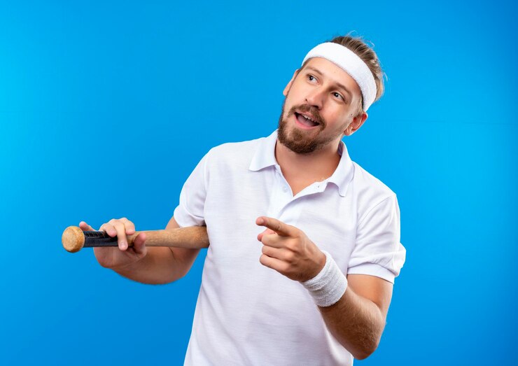 impressed-young-handsome-sporty-man-wearing-headband-wristbands-holding-baseball-bat-looking-pointing-side-isolated-blue-wall_141793-101512-min
